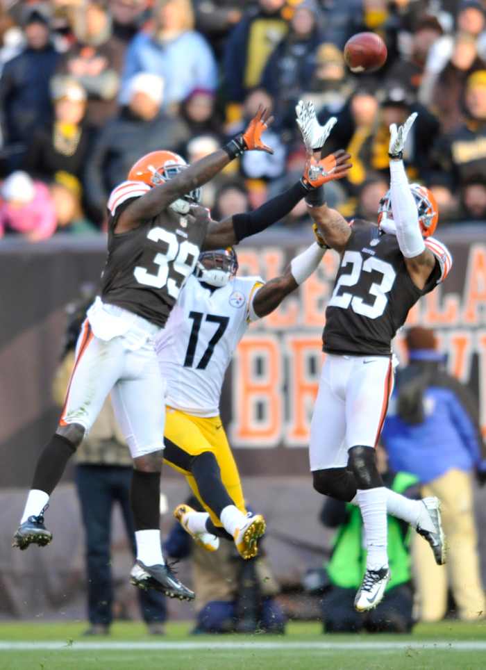 Nov 25, 2012; Cleveland, OH, USA; Cleveland Browns cornerback Joe Haden (23) intercepts a pass intended for Pittsburgh Steelers wide receiver Mike Wallace (17) in the fourth quarter at Cleveland Browns Stadium. Cornerback Tashaun Gipson (39) is also in on the play. Mandatory Credit: David Richard-USA TODAY Sports